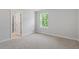 Cozy bedroom with neutral walls, carpeting, and a bright window with green views at 124 Hemlock Falls Trl # 189, Raleigh, NC 27603
