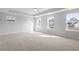 Expansive bedroom with neutral carpet, tray ceilings, and large windows that let in ample light at 124 Hemlock Falls Trl # 189, Raleigh, NC 27603