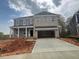 Newly constructed two-story home boasts a light brick facade and a spacious two-car garage at 124 Hemlock Falls Trl # 189, Raleigh, NC 27603