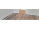 Close-up shot showcasing the light brown wood-look flooring and clean white baseboards throughout the home at 124 Hemlock Falls Trl # 189, Raleigh, NC 27603