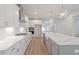 Modern kitchen with white cabinets, quartz countertops, subway tile backsplash, and stainless-steel appliances at 124 Hemlock Falls Trl # 189, Raleigh, NC 27603