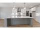 New kitchen features a spacious quartz island, stainless appliances, white cabinets, and modern pendant lights at 124 Hemlock Falls Trl # 189, Raleigh, NC 27603