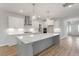 Modern kitchen includes a large island, white subway tile backsplash, and stainless steel appliances at 124 Hemlock Falls Trl # 189, Raleigh, NC 27603