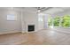 Bright living room featuring a fireplace, large windows, and hardwood floors at 124 Hemlock Falls Trl # 189, Raleigh, NC 27603