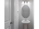 Modern powder room features a pedestal sink, neutral color scheme, and sleek lighting at 124 Hemlock Falls Trl # 189, Raleigh, NC 27603