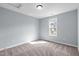 Carpeted bedroom featuring a large window providing natural light and a view of the outdoors at 127 Landfall Ln, Smithfield, NC 27577