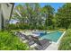 Resort-style backyard with pool, spa, lounge chairs, and lush landscaping at 132 Edward Booth Ln, Durham, NC 27713