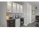 Stylish bar area featuring illuminated cabinets, a wine refrigerator, and modern tile backsplash at 132 Edward Booth Ln, Durham, NC 27713