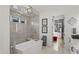 Bright bathroom featuring a modern tub, glass shower, and access to a custom walk-in closet at 132 Edward Booth Ln, Durham, NC 27713