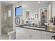 Bright bathroom featuring a modern vanity, large mirror, and glass-enclosed shower with bench seating at 132 Edward Booth Ln, Durham, NC 27713
