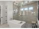 Contemporary bathroom with a sleek tub, glass-enclosed shower, and stylish lighting at 132 Edward Booth Ln, Durham, NC 27713