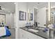 Modern bathroom with dual sinks, a black countertop, and stylish fixtures at 132 Edward Booth Ln, Durham, NC 27713
