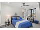 Cozy bedroom featuring a blue quilted bed, a ceiling fan, and a side table with a lamp at 132 Edward Booth Ln, Durham, NC 27713