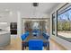Elegant dining room with a modern light fixture and a climate-controlled wine storage, offering views of the outdoors at 132 Edward Booth Ln, Durham, NC 27713