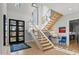 Bright entryway featuring glass staircase, modern lighting, and view of exterior landscape at 132 Edward Booth Ln, Durham, NC 27713