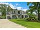 Contemporary home showcasing a spacious lawn, modern architectural design, and lush greenery at 132 Edward Booth Ln, Durham, NC 27713