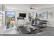 Home gym featuring modern exercise equipment, a mounted TV, and large windows for natural light at 132 Edward Booth Ln, Durham, NC 27713