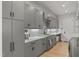 Spacious kitchen with gray cabinets, quartz countertops, and stainless steel appliances at 132 Edward Booth Ln, Durham, NC 27713