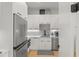 Modern white kitchen featuring stainless steel appliances, white cabinets, and a stylish backsplash at 132 Edward Booth Ln, Durham, NC 27713