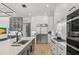 Bright kitchen with stainless steel appliances, a large island, and custom cabinetry, perfect for culinary enthusiasts at 132 Edward Booth Ln, Durham, NC 27713