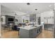 Open-concept kitchen flows into the living area, featuring a large island, modern appliances, and a seamless design at 132 Edward Booth Ln, Durham, NC 27713