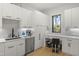 Bright kitchen with white cabinets, stainless steel appliances, desk, and a window view at 132 Edward Booth Ln, Durham, NC 27713