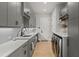 Well-equipped laundry room with gray cabinets, quartz countertops, and modern washer/dryer at 132 Edward Booth Ln, Durham, NC 27713