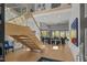 Bright, open living space with glass staircase, hardwood floors and comfortable seating area at 132 Edward Booth Ln, Durham, NC 27713
