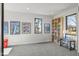 Well-lit living room with windows, a bookshelf, and decorative posters on the wall at 132 Edward Booth Ln, Durham, NC 27713