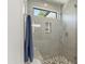 Contemporary shower with gray tile, a glass enclosure, and built-in shelves at 132 Edward Booth Ln, Durham, NC 27713