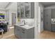 Chic wet bar area with a sink, quartz countertops, glass shelving, and custom cabinets, ideal for entertaining guests at 132 Edward Booth Ln, Durham, NC 27713
