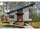 Modern two-story home with unique architectural design and landscaped front yard featuring a charming guest house at 1407 Carroll St, Durham, NC 27707