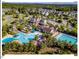 Stunning aerial view of the community clubhouse, pools, and surrounding homes nestled among lush greenery at 153 Abercorn Cir, Chapel Hill, NC 27516