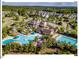 Stunning aerial view of the community clubhouse, pools, and surrounding homes nestled among lush greenery at 153 Abercorn Cir, Chapel Hill, NC 27516