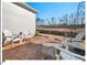 Relaxing backyard patio with stone floor and Adirondack chairs facing the natural backdrop at 153 Abercorn Cir, Chapel Hill, NC 27516