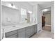 Bathroom boasts double vanity, framed mirrors, with plenty of light from the window at 153 Abercorn Cir, Chapel Hill, NC 27516