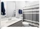 Clean bathroom with a modern vanity, shower with gray striped curtain, providing a functional and stylish space at 153 Abercorn Cir, Chapel Hill, NC 27516