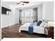 Cozy bedroom with a ceiling fan, natural light streaming through large windows, and modern décor creating a serene retreat at 153 Abercorn Cir, Chapel Hill, NC 27516