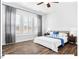 Stylish bedroom featuring large windows, modern décor, and hardwood floors, creating an inviting space for relaxation at 153 Abercorn Cir, Chapel Hill, NC 27516