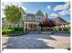 Stately home featuring manicured landscaping, a covered entryway with columns, and an adjacent outdoor gazebo area at 153 Abercorn Cir, Chapel Hill, NC 27516