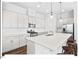 Bright kitchen with white cabinets, granite countertops, a center island with seating, and stainless steel appliances at 153 Abercorn Cir, Chapel Hill, NC 27516
