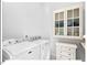 Convenient laundry room equipped with modern washer and dryer units, complemented by custom storage cabinets and counter space at 153 Abercorn Cir, Chapel Hill, NC 27516