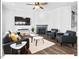 Cozy living room featuring a fireplace, hardwood floors, stylish furniture, and modern decor at 153 Abercorn Cir, Chapel Hill, NC 27516