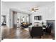 Bright living room with hardwood floors, fireplace, large windows, and stylish modern furniture at 153 Abercorn Cir, Chapel Hill, NC 27516