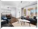 Inviting living space with hardwood floors, large windows, and an open-concept layout to the dining area at 153 Abercorn Cir, Chapel Hill, NC 27516
