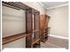 Custom walk-in closet with shelving, hanging racks and wood-look floors at 153 Abercorn Cir, Chapel Hill, NC 27516