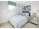 Comfortable bedroom showcases a bed, decorative pillows, side table, and natural light from the window at 165 Sunny Acres Rd, Garner, NC 27603