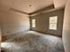 Unfinished bedroom area with tray ceiling and natural light from dual windows with exterior views at 20 Trescott St, Smithfield, NC 27577