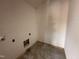Unfinished laundry room area featuring rough-in plumbing and sheetrocked walls, ready for appliances at 20 Trescott St, Smithfield, NC 27577