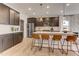 Modern kitchen island features an undermount sink, stainless steel appliances, and dark hardwood cabinets at 2001 Regal Dr # 89, Durham, NC 27703